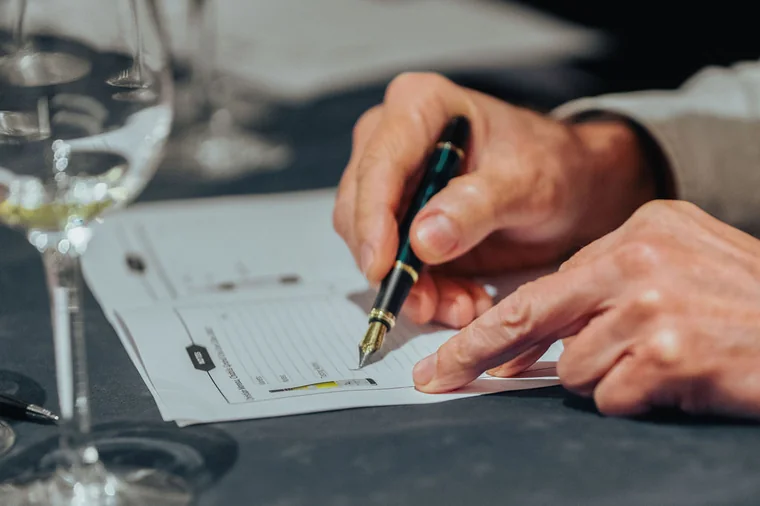 Close-up of notes being written during an event planning session in Cyprus