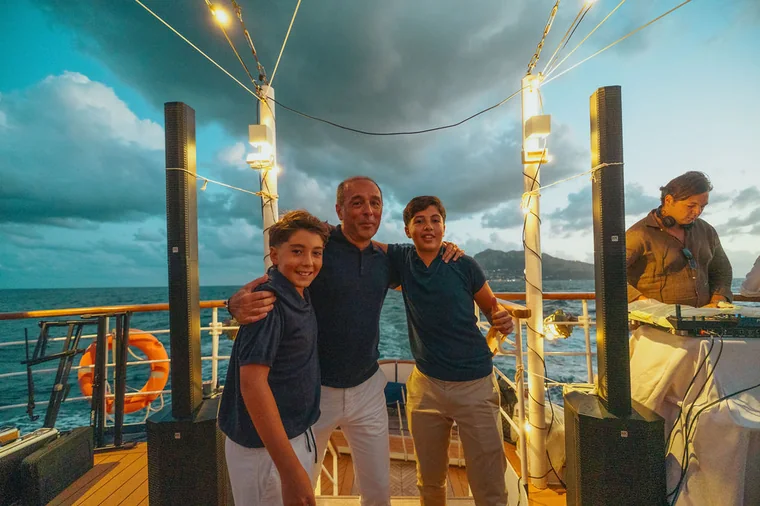 Family and guests gathered on a boat during an event in Cyprus