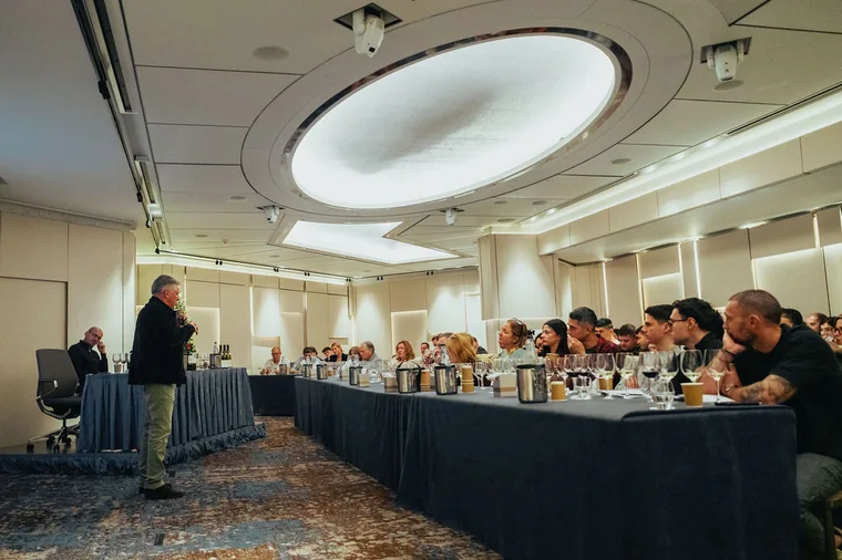 Guests seated at a tasting event in Cyprus with hospitality atmosphere